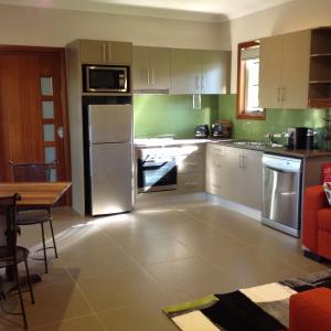 A kitchen or kitchenette at Mistinthegumtrees Eco Luxury Cabins