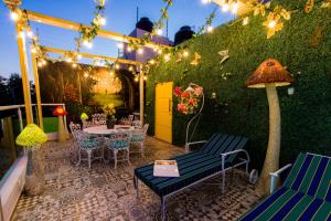 a patio with a table and chairs and lights at Once21 Apartment in Guadalajara