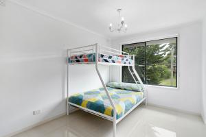 a bunk bed in a white room with a window at Fairhills - beautifully styled in Rye