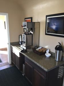 a kitchen with a counter top with a coffee maker at Shady Motel in Caliente