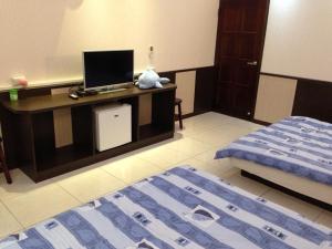 Postel nebo postele na pokoji v ubytování Luyi Ludao B&B