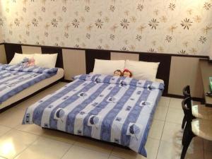 Postel nebo postele na pokoji v ubytování Luyi Ludao B&B