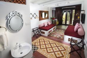 a bathroom with a sink and a mirror at Jawi Peranakan Mansion in George Town +34 photos