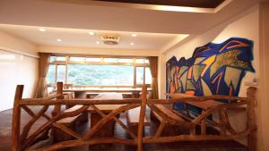a room with a table and chairs and a window at Liwu Hotel Taroko in Fushi