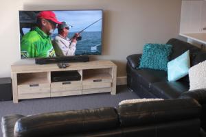 A television and/or entertainment center at Sails Resort Golden Beach