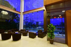 a lobby with couches and chairs in a building at Siam Oriental Hotel in Hat Yai