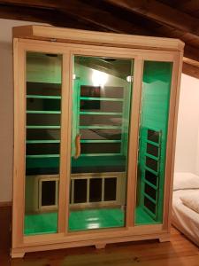 a wooden cabinet with glass doors in a room at Nof Sadot in Naẖam