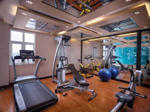 a gym with several treadmills and exercise bikes at Silk Path Hotel Hanoi in Hanoi