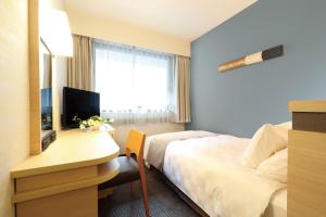 Postel nebo postele na pokoji v ubytování Karasuma Kyoto Hotel