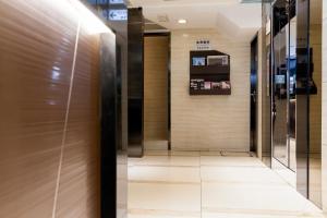 a hallway with elevators in a building at Pop Inn Mong Kok in Hong Kong