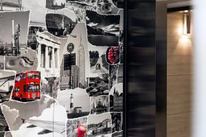 a wall mural of a city with a red bus at Pop Inn Mong Kok in Hong Kong