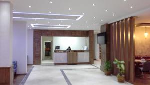 a lobby with a reception desk in a building at Hande Hotel in Mustafakemalpaşa