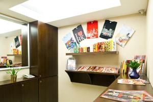 a room with a desk and shelves with books at Pop Inn Mong Kok in Hong Kong