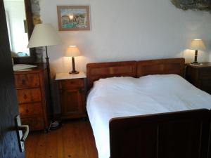 a bedroom with a bed and two night stands with lamps at Kmetija Medljan in Izola