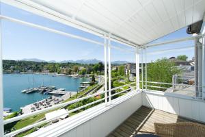 a balcony with a view of a marina at Seehotel Hubertushof in Velden am Wörthersee