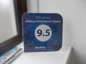 a sign for a holiday home battery square on a window at Stornoway Self-Catering Barony Square in Stornoway