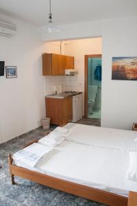a bedroom with a large bed in a room at Peristerianos apartments in Nea Skioni
