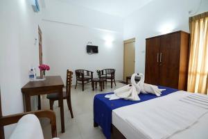 Postel nebo postele na pokoji v ubytování Hotel Oviya