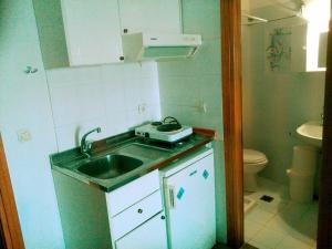 a small kitchen with a sink and a toilet at Peristerianos apartments in Nea Skioni +127 photos