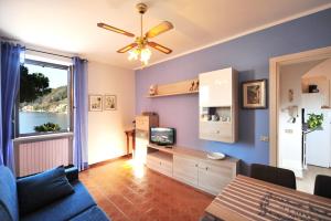 a living room with a couch and a tv at Casabb in Toscolano Maderno
