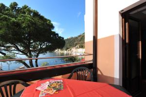 a balcony with a table and a view of the water at Casabb in Toscolano Maderno