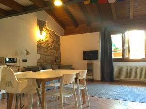 a dining room with a wooden table and chairs at CAMP 4 in Arco