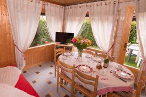 a dining room with a table with flowers on it at Le Petit Chalet in Morzine