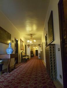 a hallway of a building with a chandelier at Hotel Nico in Medinaceli