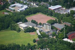 an aerial view of a building with a large park at RTB-Hotel - Sportschule in Bergisch Gladbach