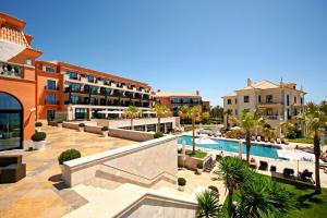 a resort with a swimming pool and some buildings at Grande Real Villa Itália Hotel & Spa in Cascais