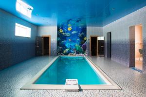
a room with a pool and a blue floor at Russkoe Podvorie in Rostov

