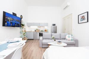 a living room with a couch and a table at Chill apartments in Prague