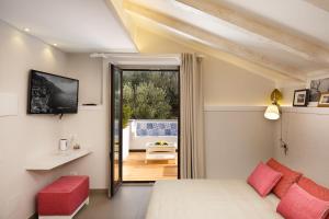 a bedroom with a bed and a view of a patio at MelRose Relais in Massa Lubrense