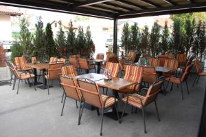 a group of tables and chairs sitting on a patio at Guest House Goršič in Grosuplje