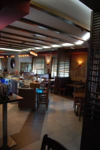 a dining room with tables and chairs in a restaurant at Guest House Goršič in Grosuplje