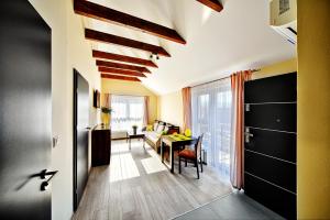 a living room with a table and a dining room at Apartamenty Salt Delux in Wieliczka