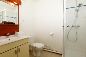 a bathroom with a shower and a toilet and a sink at Appart'City Classic Rennes Beauregard in Rennes