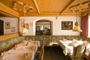 ein Esszimmer mit zwei Tischen in einem Restaurant in der Unterkunft Hotel Hauserwirt in Münster