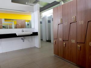 a bathroom with a sink and a mirror at Nunia Inn Bandara Jakarta in Tangerang