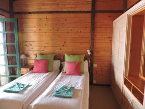 a bedroom with a bed in a wooden wall at Apartamentos Santa Ana - Adults Only in Playa de Santiago