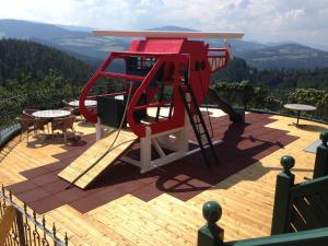 a playground on top of a deck with a view at Autobahnrestaurant & Motorhotel Zöbern in Zöbern