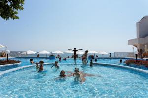 a group of people swimming in a swimming pool at Marina Hotel, Sunny Day in Saints Constantine and Helena