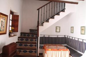 a room with stairs with a table and a stair case at Casa Rural Casa Ronda in El Bosque +16 photos
