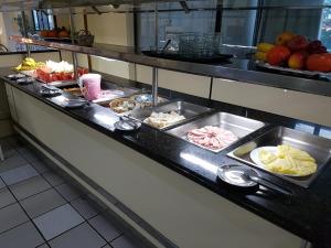 a buffet line with many different types of food at Hotel Super Economico in Vitória +32 photos