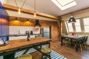 a kitchen and dining room with a table and chairs at Wishlist Old Prague Residences - Charles Bridge in Prague