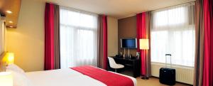 Llit o llits en una habitació de Amrâth Hotel Media Park Hilversum