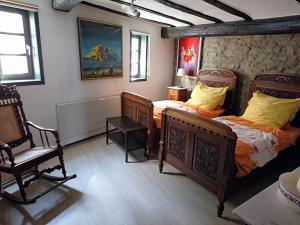 a bedroom with two beds and a chair in it at Rütsche 10 in Limburg an der Lahn