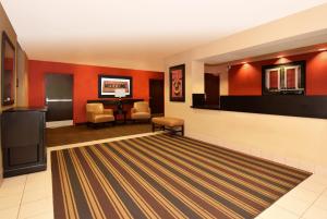 a lobby with red walls and a waiting room at Extended Stay America Suites - Detroit - Southfield - I-696 in Farmington Hills