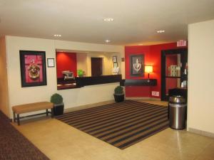 a hotel lobby with red walls and a carpet at Extended Stay America Suites - Sacramento - West Sacramento in West Sacramento
