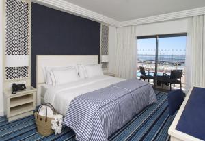 a bedroom with a bed and a view of the ocean at Real Marina Hotel & Spa in Olhão